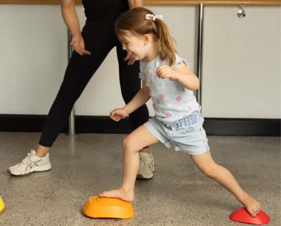 Paediatric physiotherapist treating a small girl
